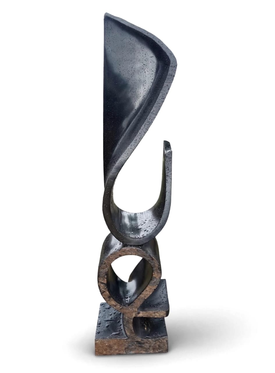 Tall dark spiral sculpture with a rust-coloured base, on white