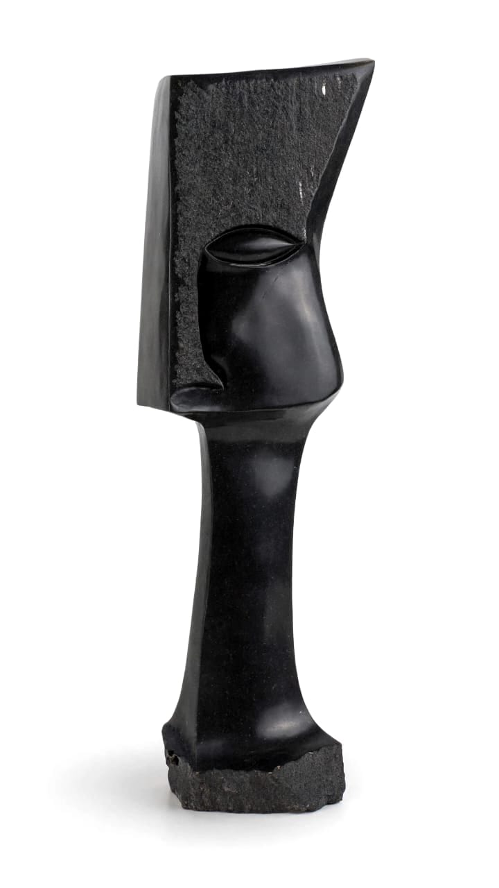 Tall polished black stone head on a long neck with a carved leaf-shaped eye, on white
