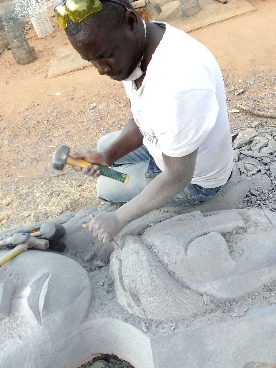 Close view of hammer and chisel work on a carved face
