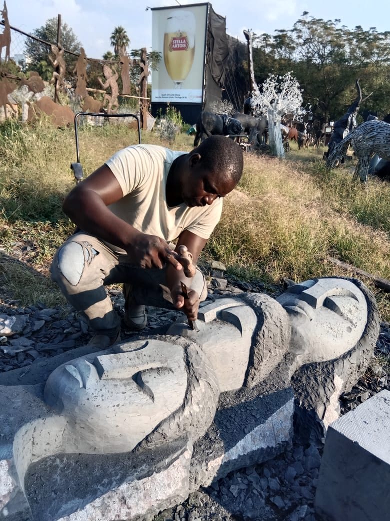 Close view of the defined faces being finished by hand