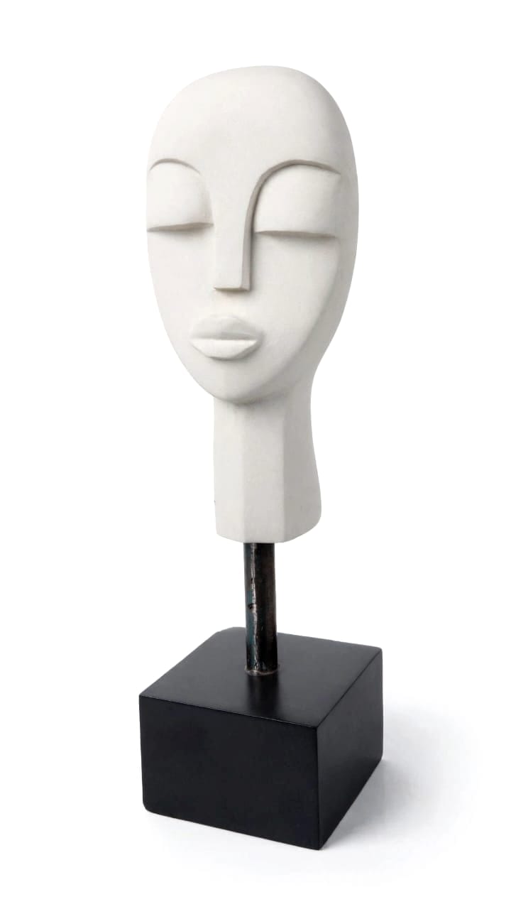 Pale stone head with closed eyes and a steel rod rising to a black square base, on white
