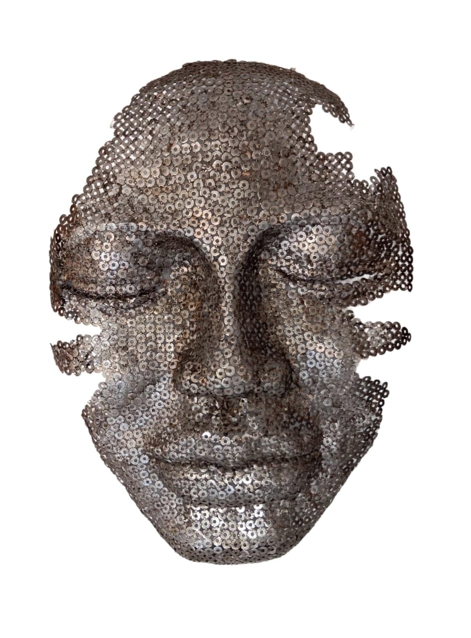 Metal face mask built from washers, on white