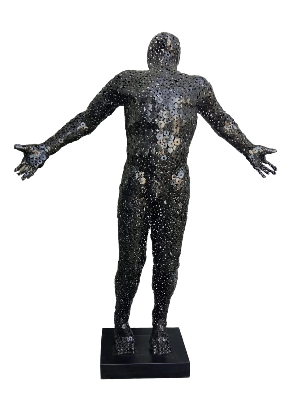 Standing male figure built from washers, arms outstretched, on a black base