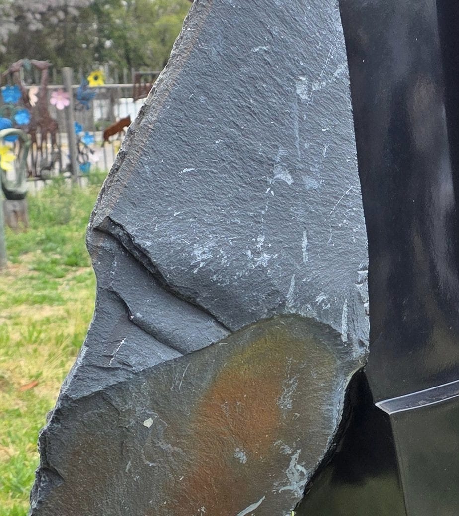The rough-cut outer face, with the natural patina of the stone