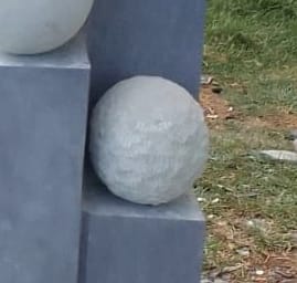 A rough-cut sphere beside the smooth ones