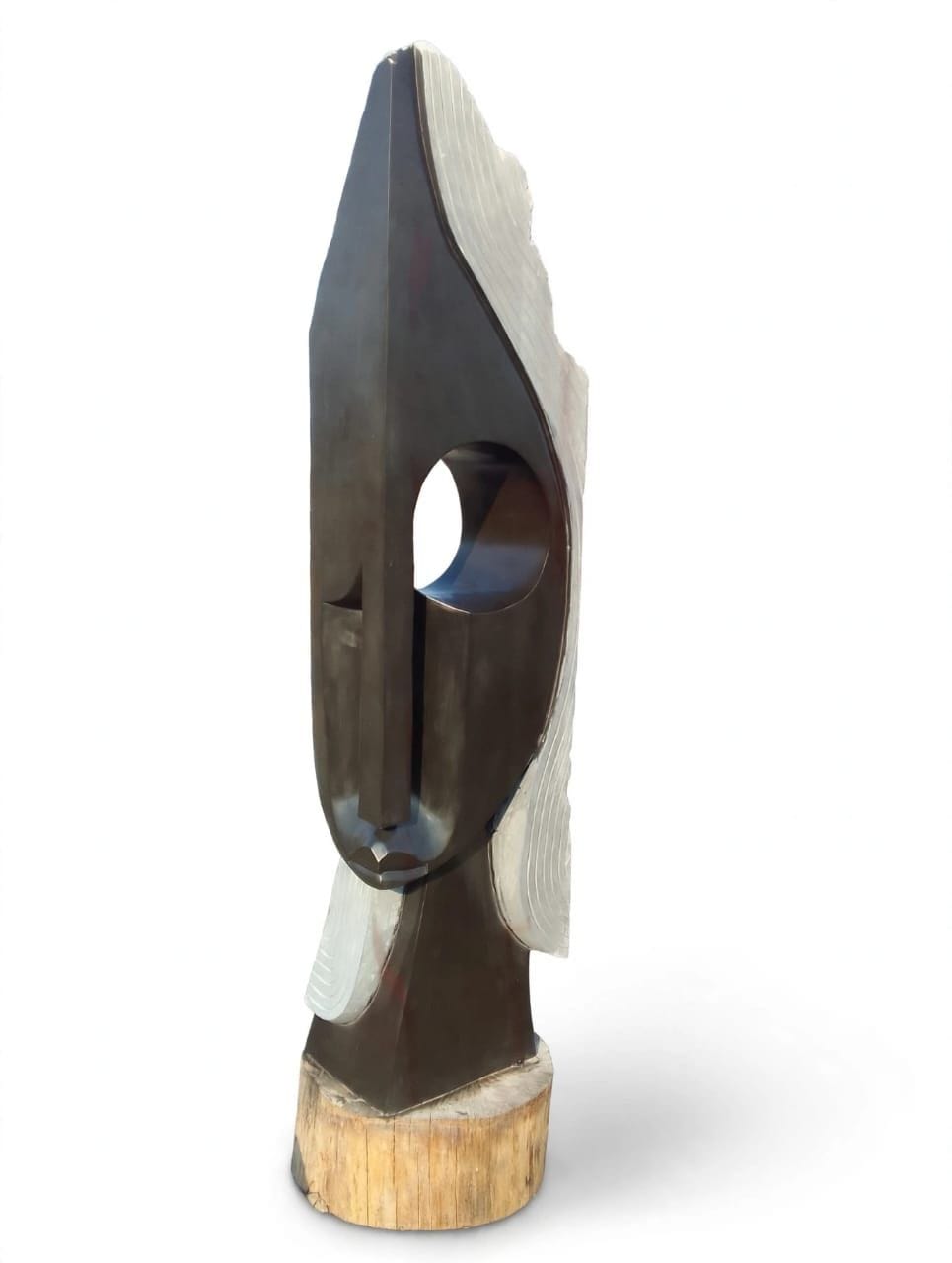Tall pod-shaped stone head with a deep oval eye and a pale ribbed edge, on a wooden base, on white
