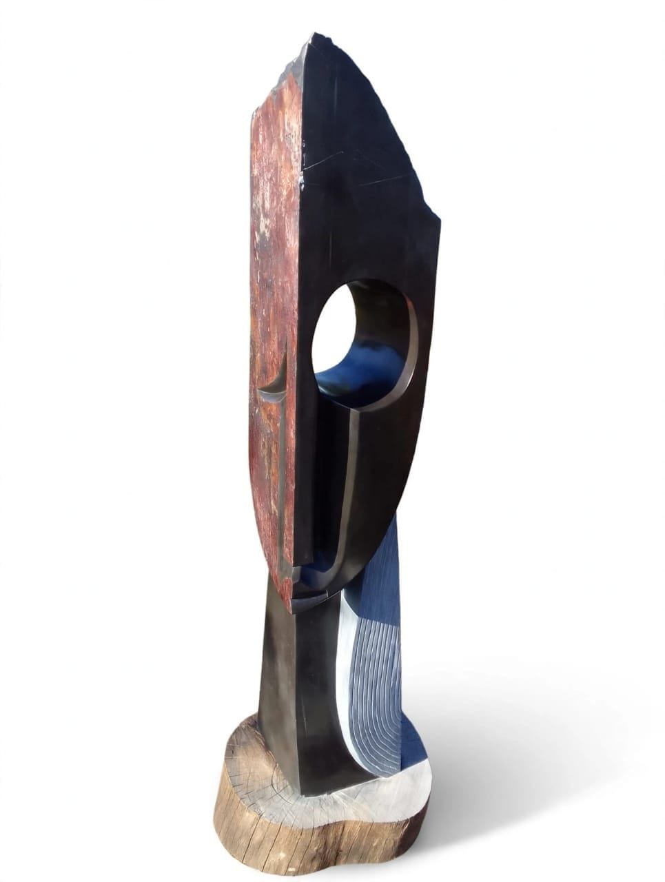 Tall stone mask keeping the rust-coloured rind of the block, with a polished oval eye, on white