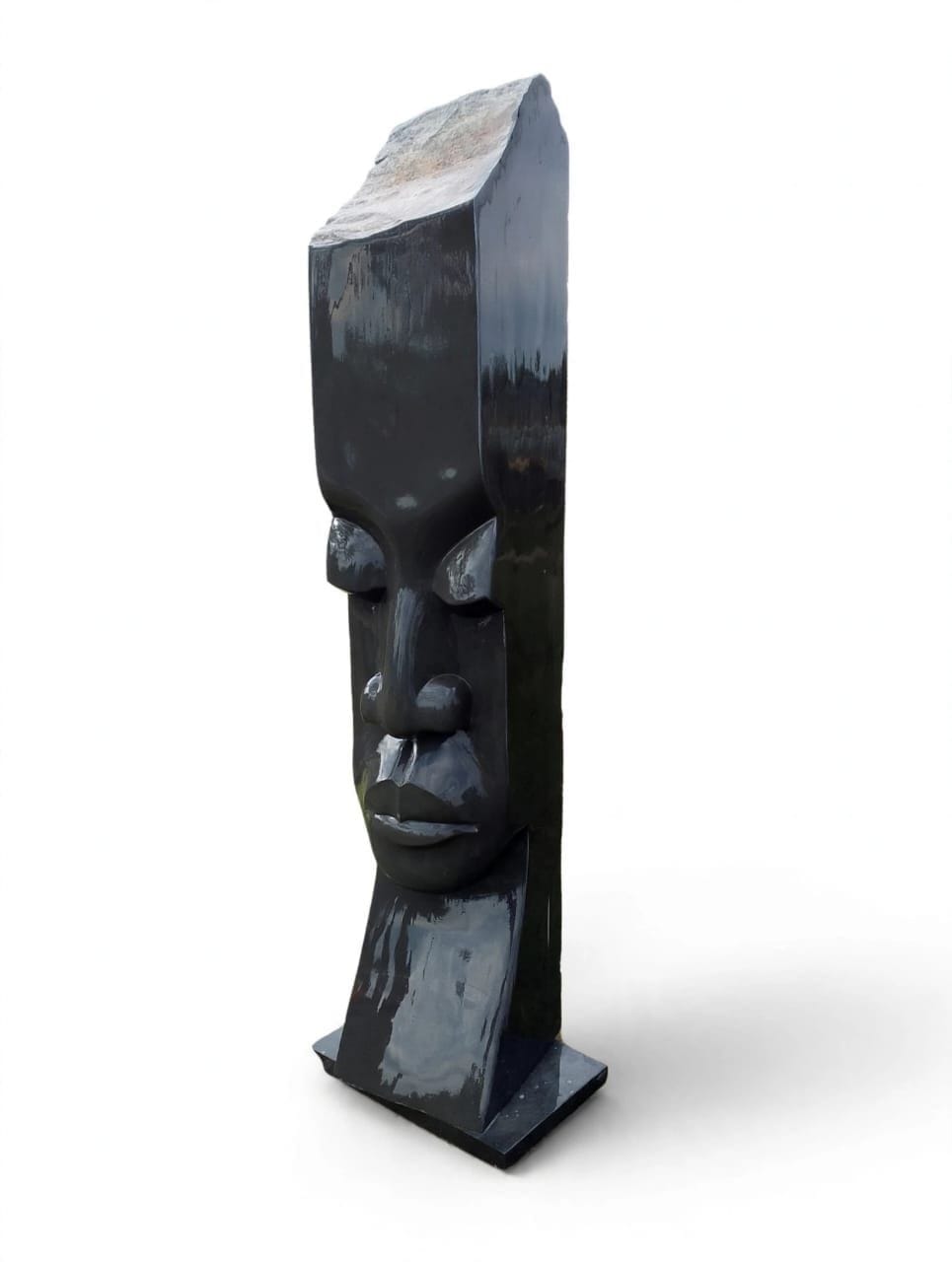 Tall flat stone column with a polished face carved low on its front, on white