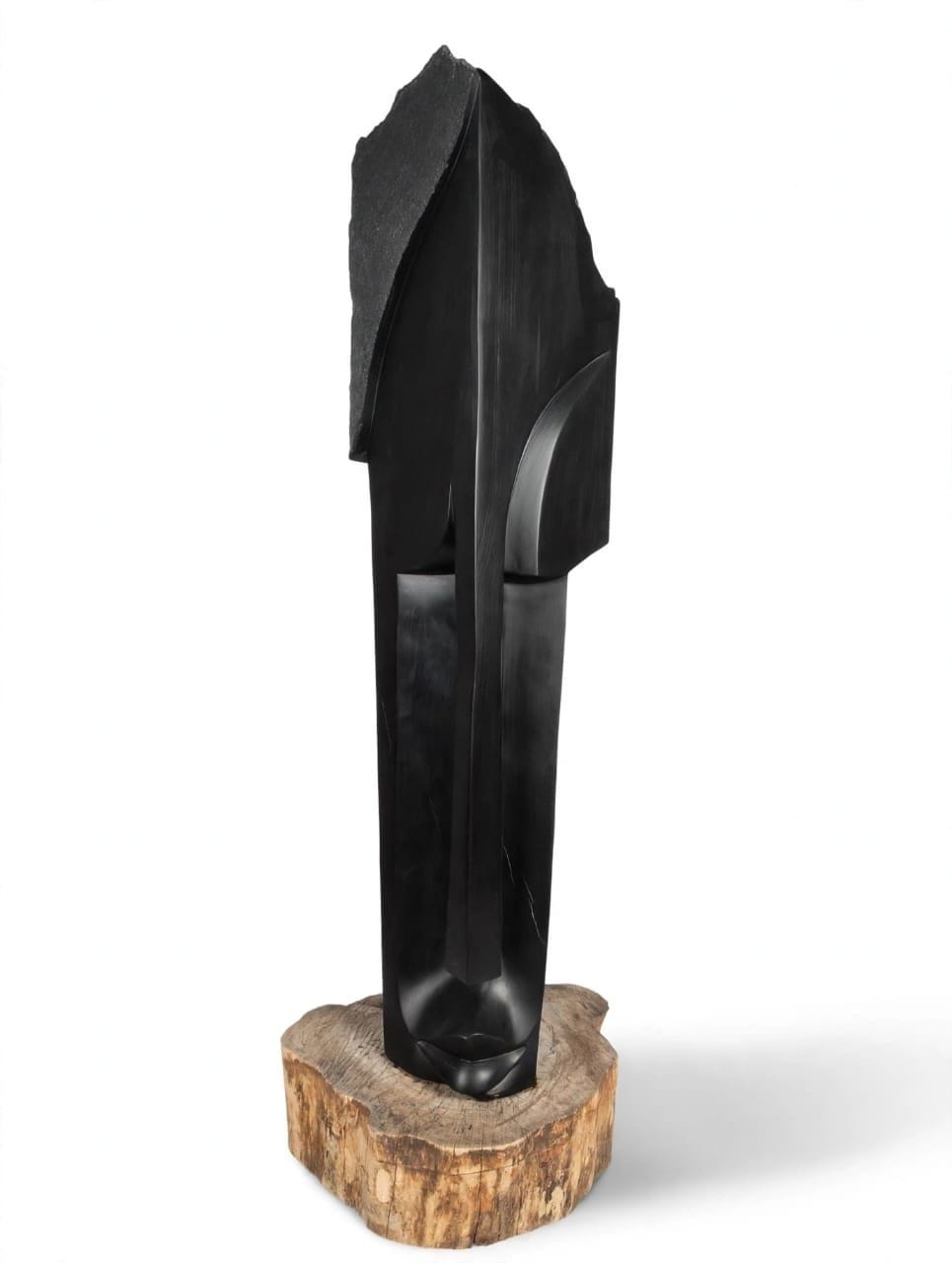 Tall polished dark stone blade with a narrow face along its edge, on a wooden base, on white
