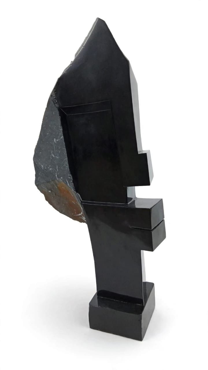 Standing stone figure with a rough-textured veil over a polished head, on white