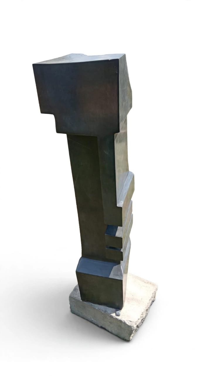 Tall dark stone tower with a recessed step and projecting blocks, on white