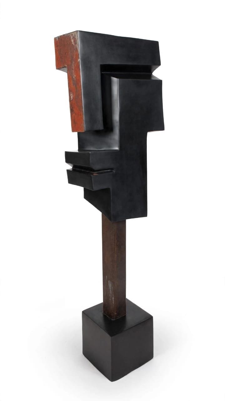 Stepped dark stone profile with rust-coloured edges, raised on a stem and square base, on white